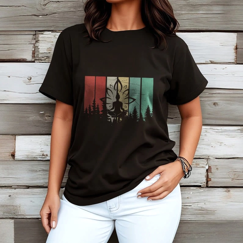 Female model wearing black spiritual Buddhist t-shirt with forest meditation graphic paired with light blue denim