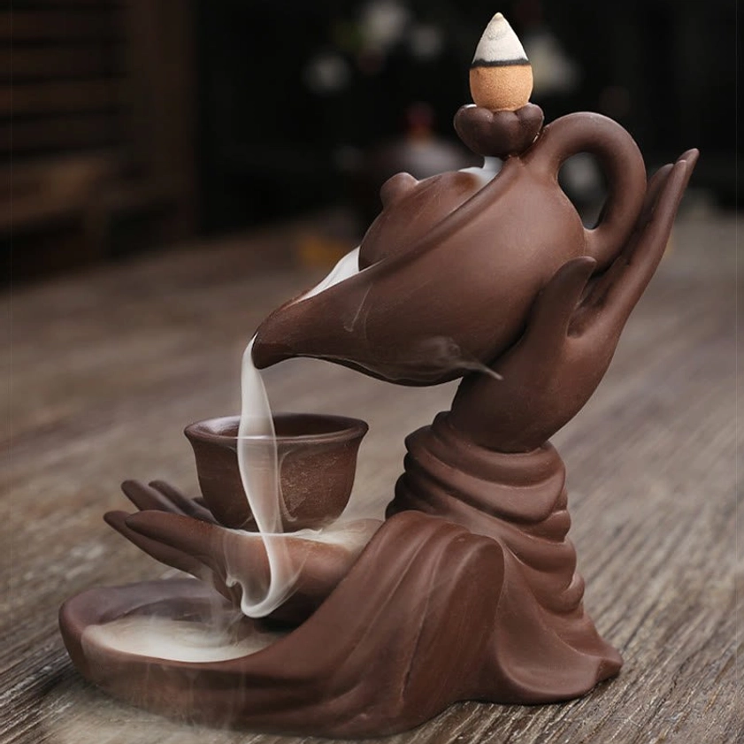 Artisanal Buddha hand backflow incense burner showing matte ceramic finish and smoke flowing design
