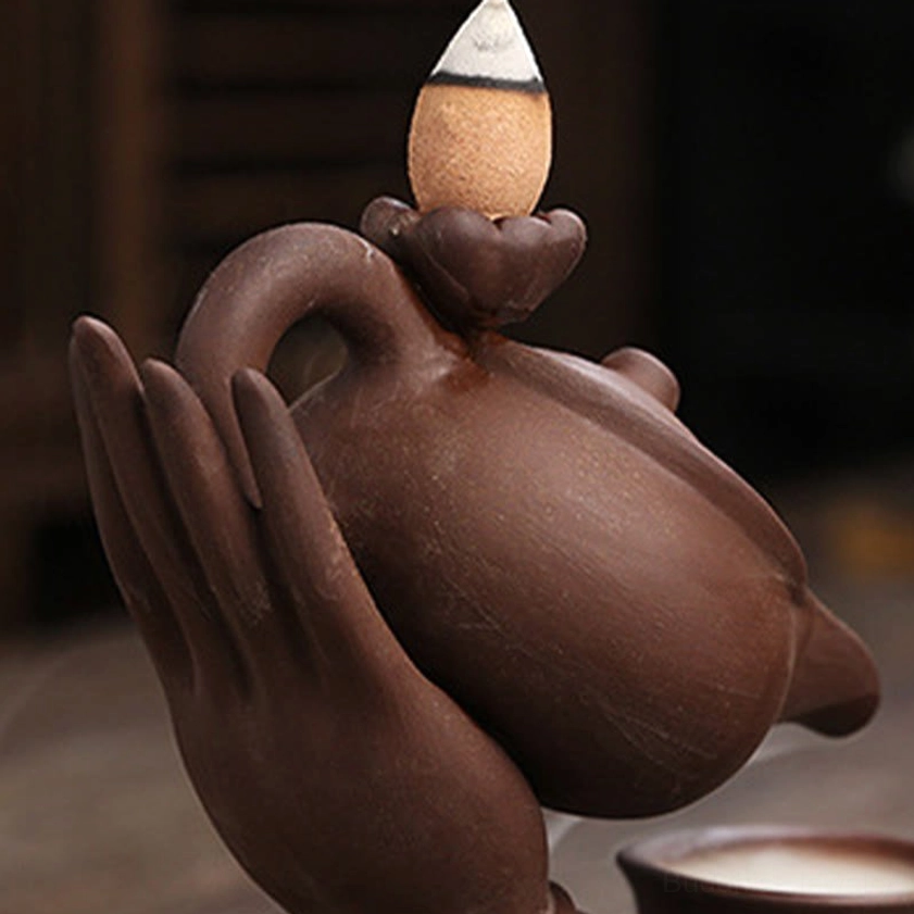 Another angle of handmade Buddha hand ceramic backflow incense burner with active smoke flow demonstration