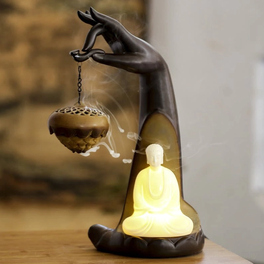 Zen Buddha Hand Ceramic Incense Burner with Flowing Backflow Smoke Effect - Warm LED Lighting on Wooden Table
