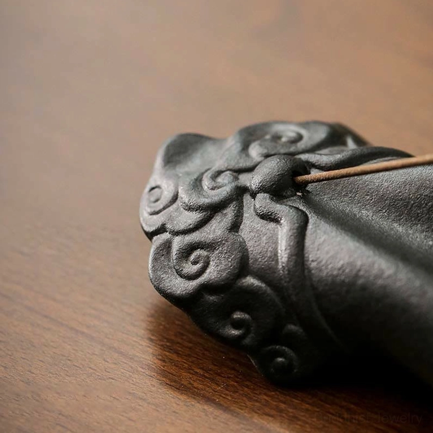 Close-up detail of auspicious cloud carving on Buddha hand ceramic incense burner wrist