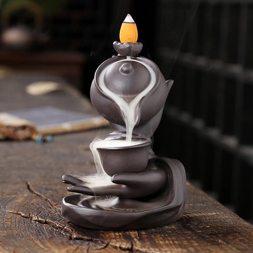 Front view of handcrafted Buddha hand incense holder displaying symmetrical backflow smoke flowing into cup