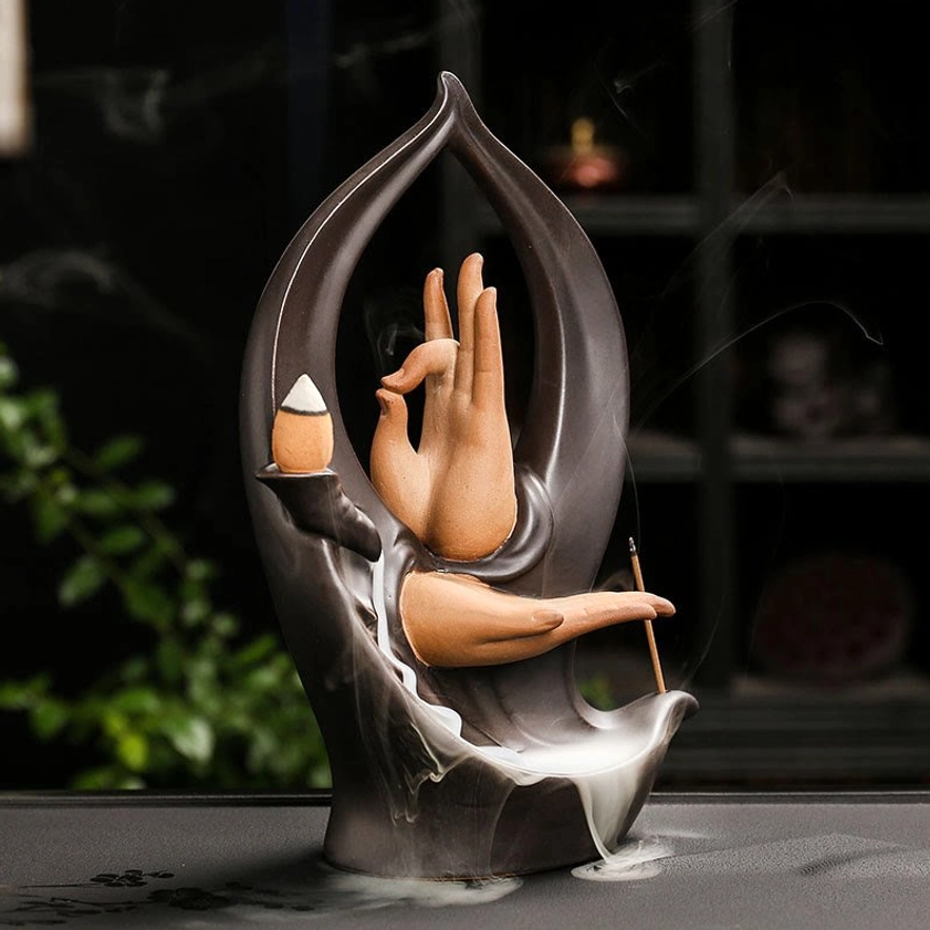 Buddha Hand ceramic backflow incense burner with reverse teaching mudra pose in matte dark brown ceramic with dramatic smoke waterfall