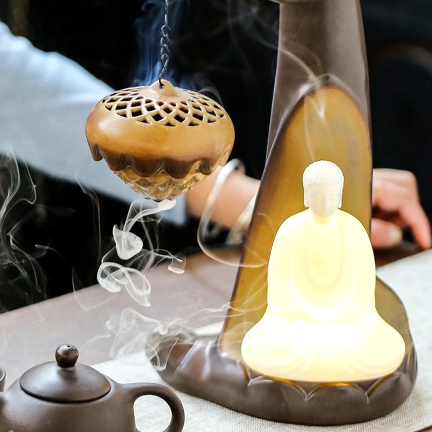 Buddha Hand Ceramic Incense Burner - Front Side View with Hands Adjusting Censer, Tea Table Setting with Flowing Smoke