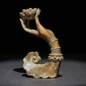 Handcrafted brass Buddha's hand lotus statue with beaded wrist bands - left three-quarter view on dark background