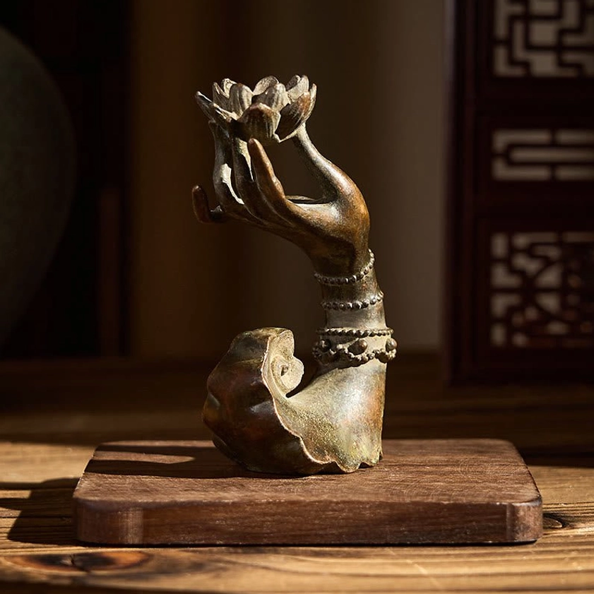 Brass Buddha's hand lotus ornament on wooden pedestal with beaded bracelets - Chinese interior design setting