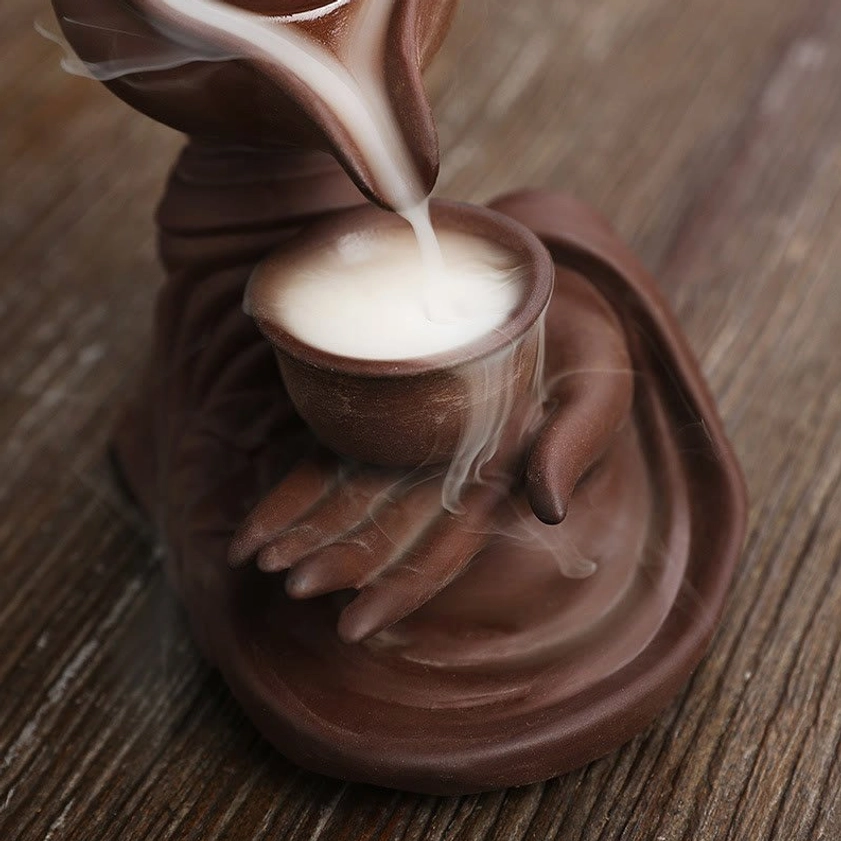 Artistic view of Buddha hand ceramic teapot incense burner with beautiful backflow smoke pattern