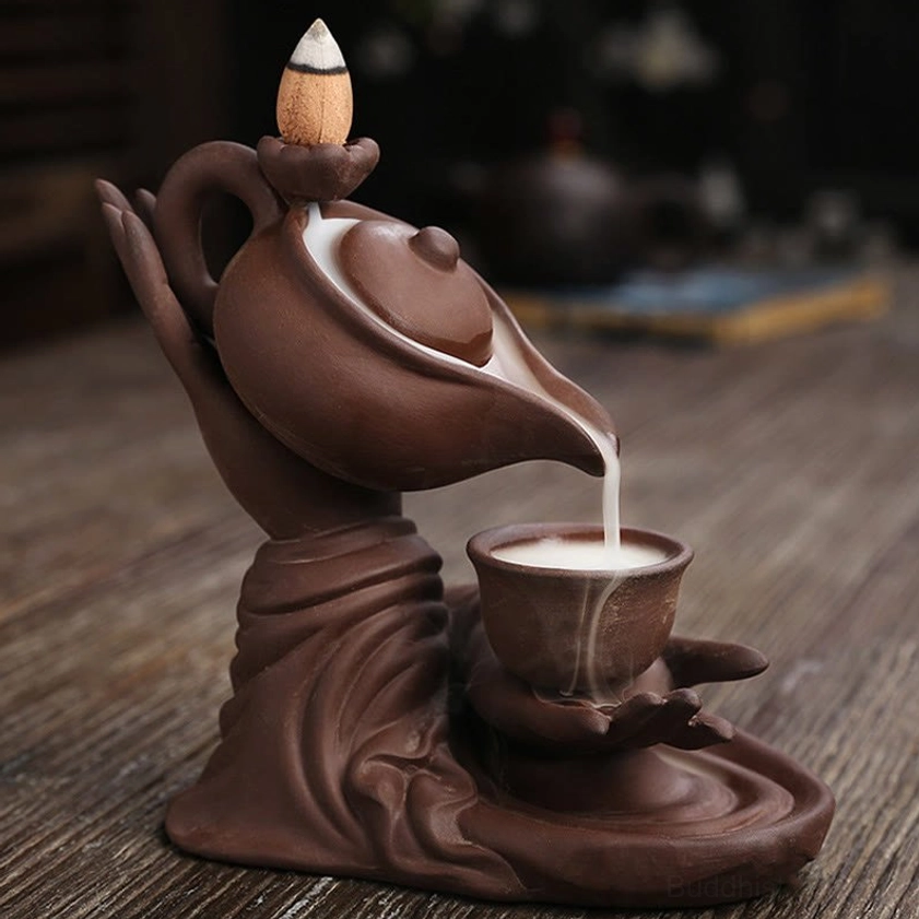 Detailed view of Buddha hand teapot incense burner with graceful smoke waterfall into collection base