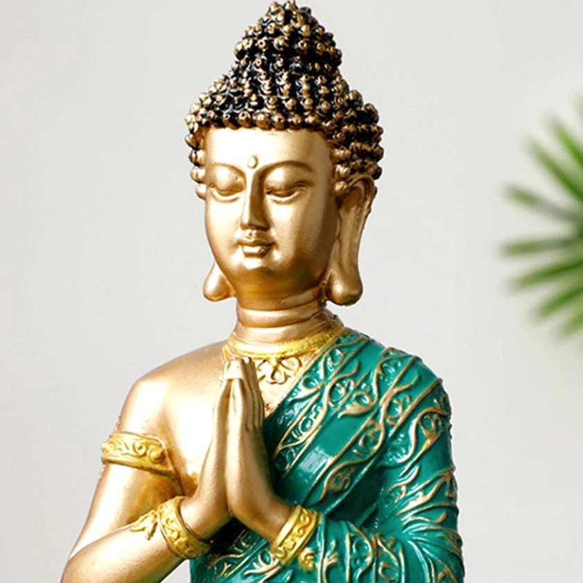 Detailed close-up of Buddha head showing curled hair, golden facial features, and serene expression