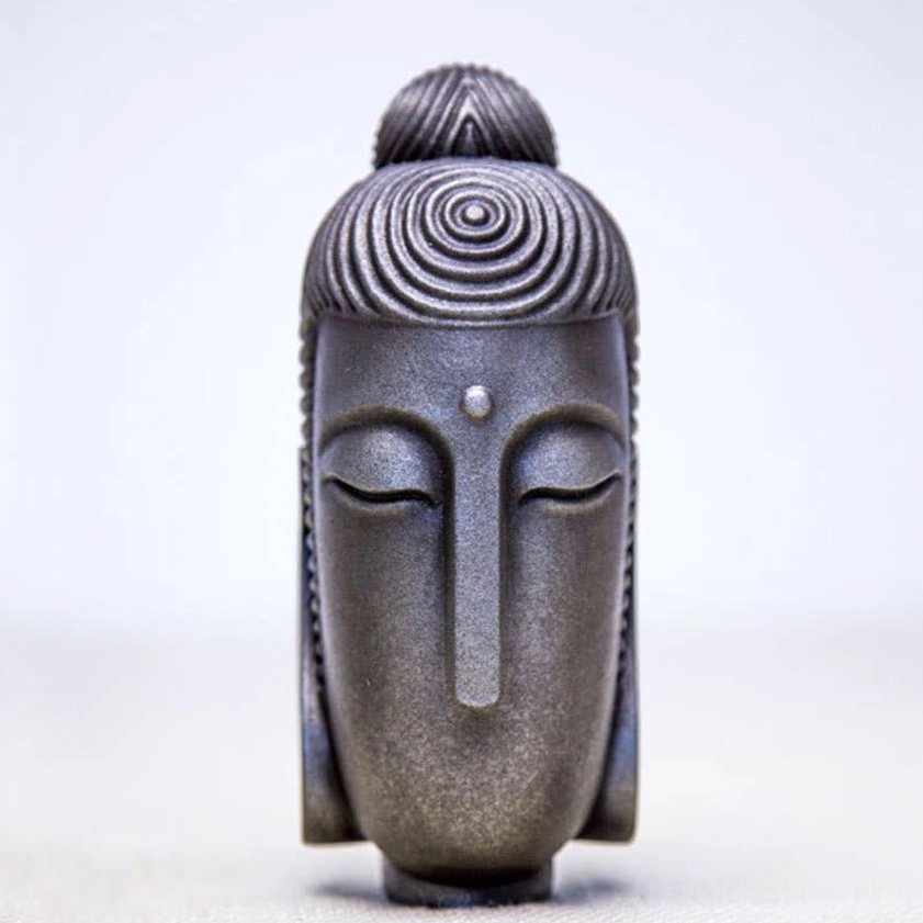Polished meditating Buddha head sculpture with refined finish and peaceful closed eyes detail