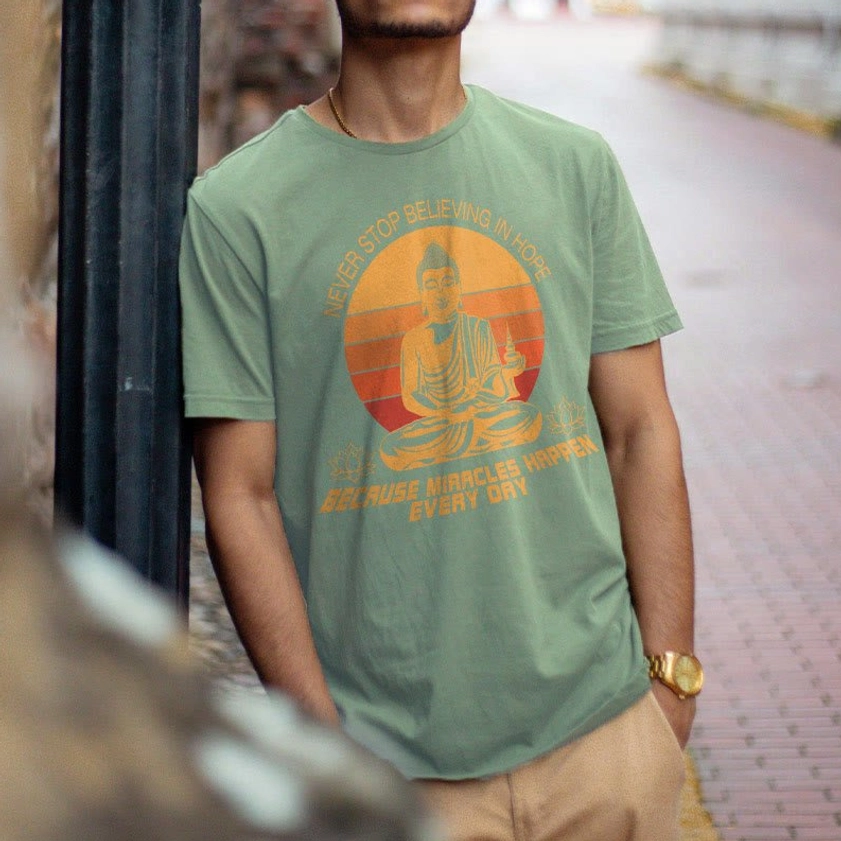 Buddha's Hope casual tee - model wearing dusty green cotton shirt with retro Buddha graphic outdoor lifestyle