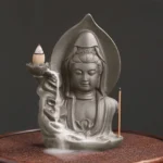 Avalokitesvara Buddha lotus backflow incense burner with flowing smoke cascade - front three-quarter view