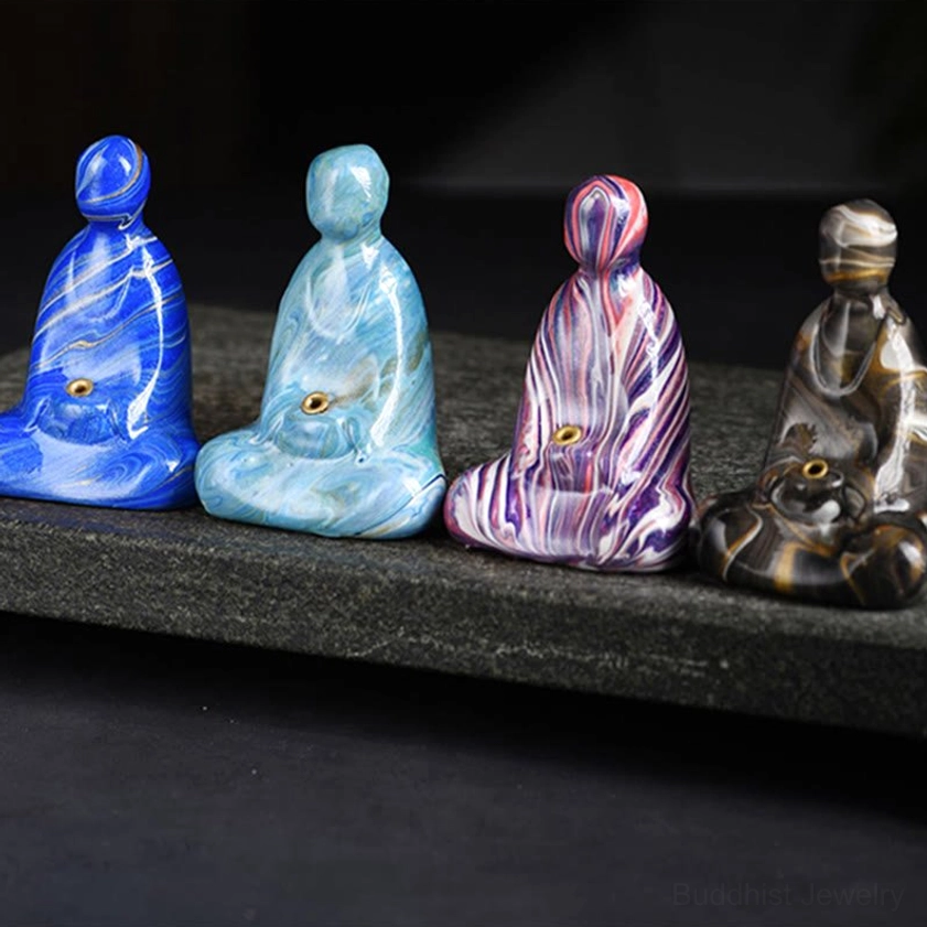 Buddha incense holder flat lay view emphasizing symmetrical design and marbled lacquer finish