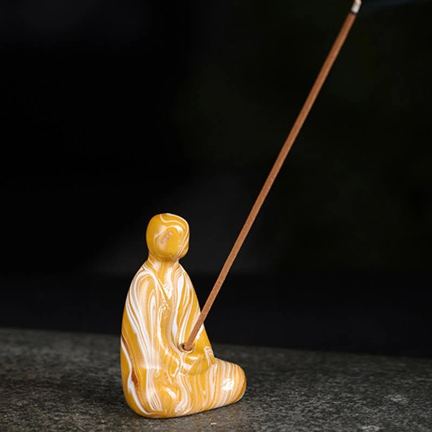 Buddha incense holder lifestyle shot in meditation room or spiritual sanctuary setting