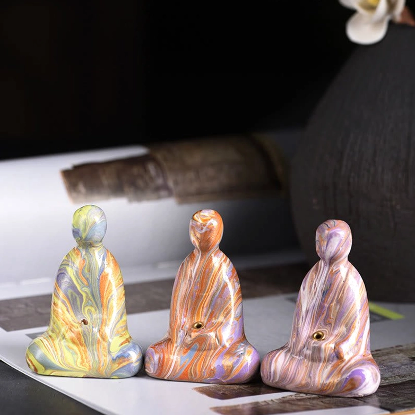 Buddha incense holder product shot with professional lighting highlighting lacquer gloss and detail