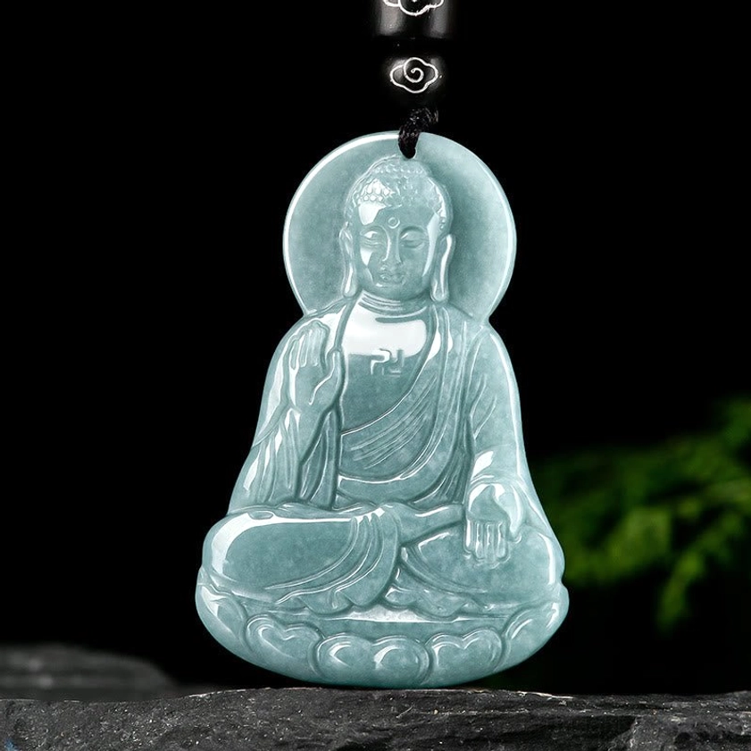 Hand-carved Amitabha Buddha jade amulet close-up detail polished jade carving with Buddha halo and lotus base