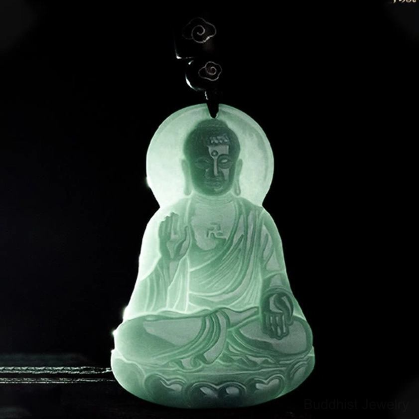 Light green translucent Amitabha Buddha jade pendant backlit view showing jade clarity and Buddha carving
