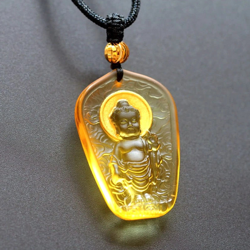 Bright amber Baby Buddha Liuli crystal pendant - vibrant golden glaze with haloed Buddha figure and cloud textures handcrafted