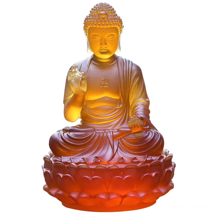 Handcrafted Liuli crystal Buddha statue isolated white background showing cross-legged lotus seating and amber-red translucent glaze