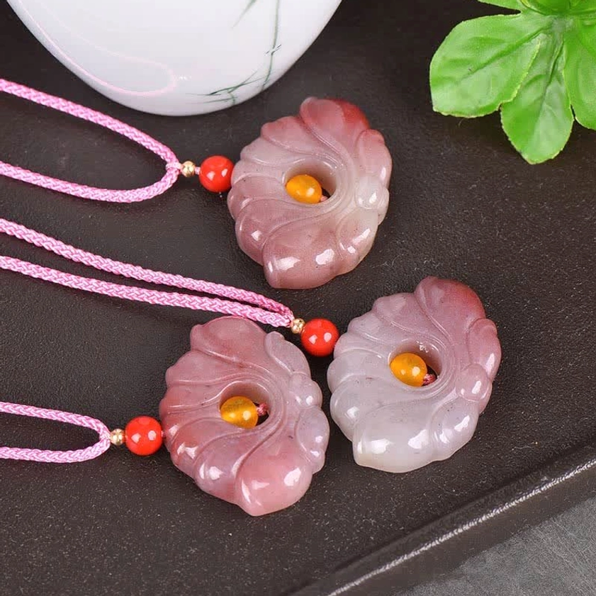 Multiple lotus flower jade pendants in varying pink shades for meditation and spiritual practice
