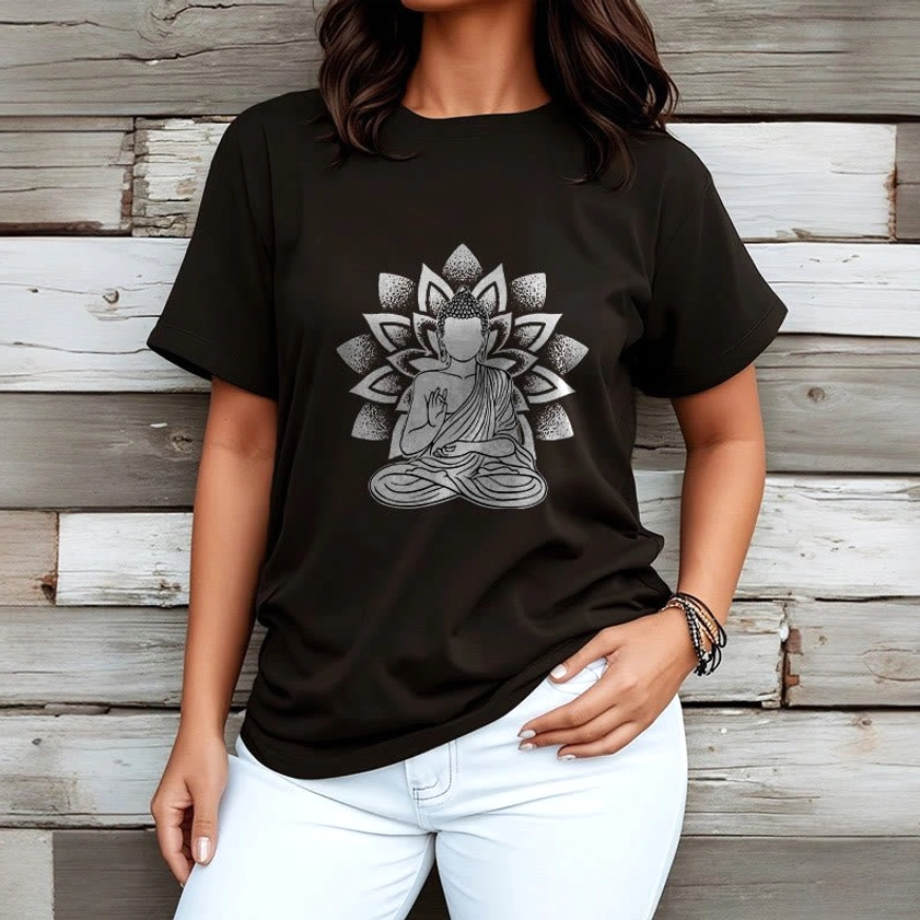 Woman wearing black Buddha lotus print t-shirt with white trousers wooden backdrop