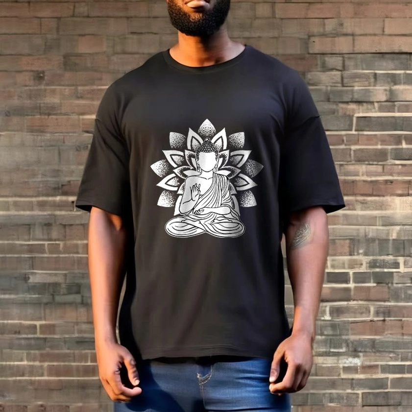 Man in black Buddhist lotus spiritual t-shirt with blue denim outdoor brick wall