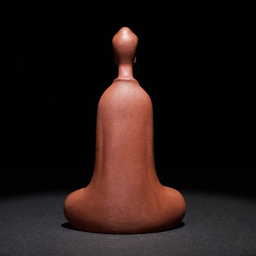 Purple clay Buddha statue rear view showing unadorned back and natural matte finish