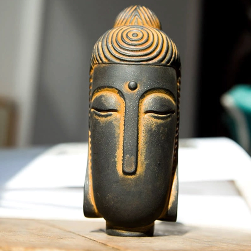 Serene Buddha head sculpture with aged rusty texture and peaceful closed eyes close-up