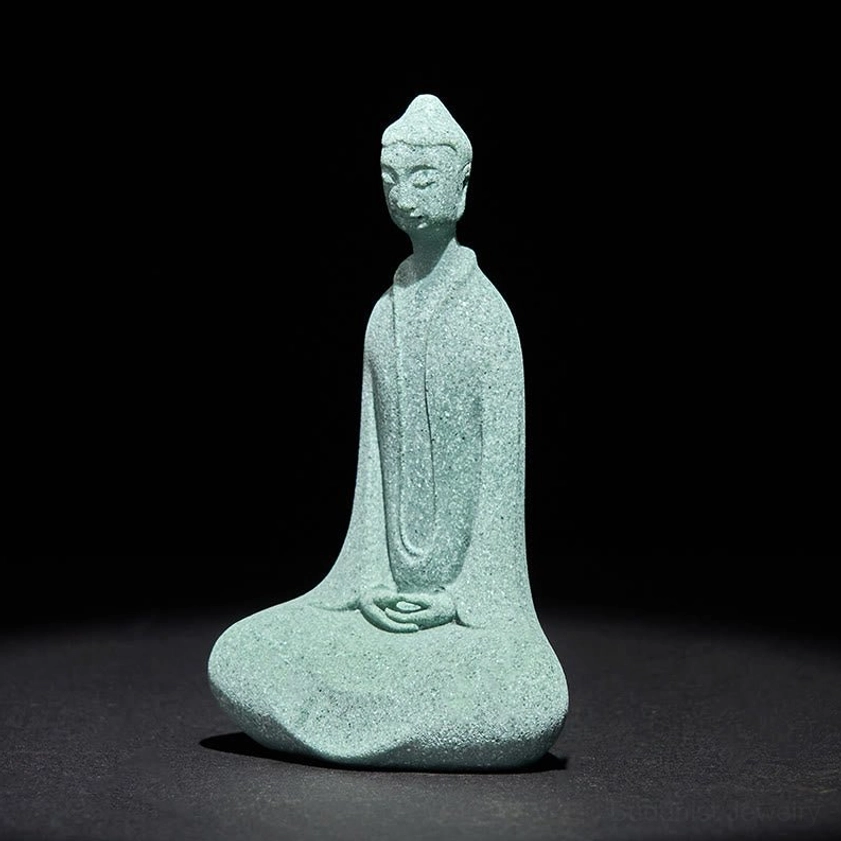 Left side profile view of serene Buddha meditation statue highlighting natural sandstone texture and craftsmanship