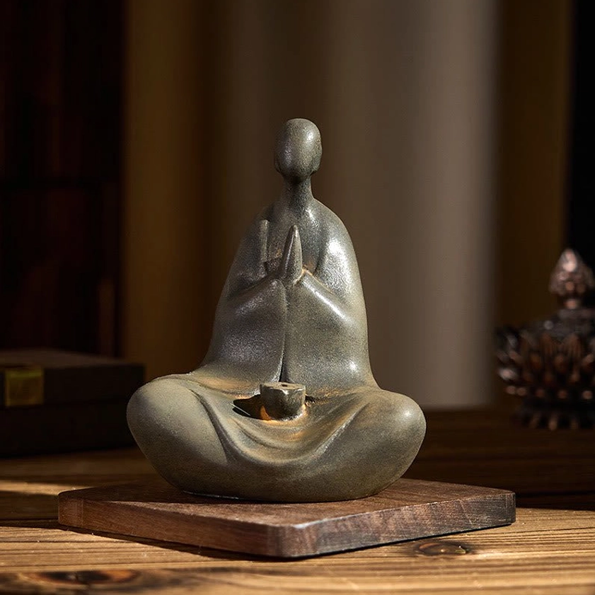 Formless Buddha sculpture three-quarter side view with decorative display setup, contemplative pose