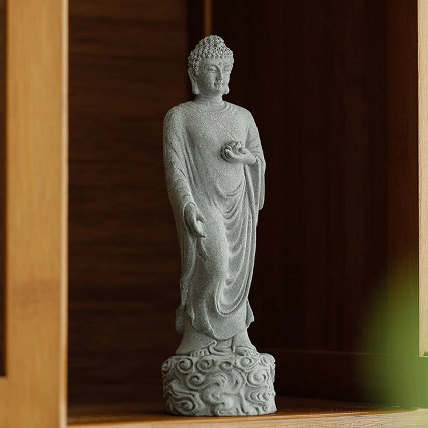 Buddha statue with matte gray finish displayed on wooden altar shelf cabinet