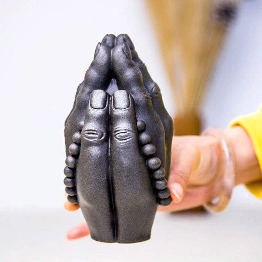 Buddha hand namaste gesture statue combining spiritual symbolism with artisanal craftsmanship for meaningful home decoration