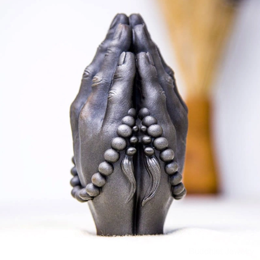 Buddhist Namaste hand gesture statue with sacred symbolism representing compassion and inner peace for spiritual seekers
