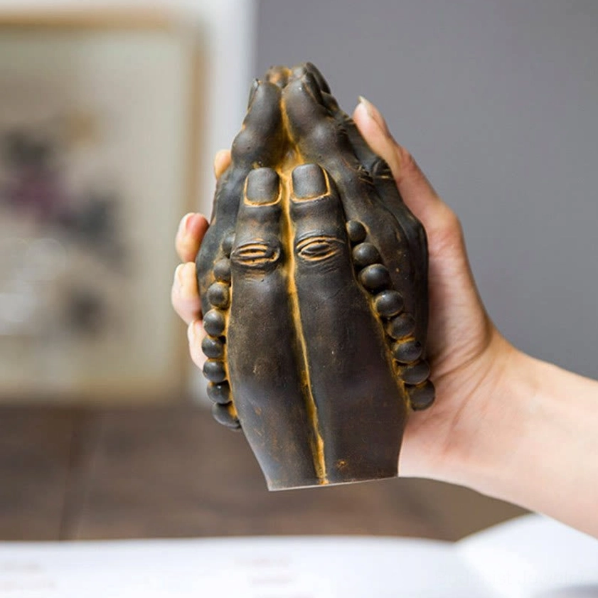Handmade Buddha Namaste hand statue held in human palm to show actual size and scale of meditation décor piece