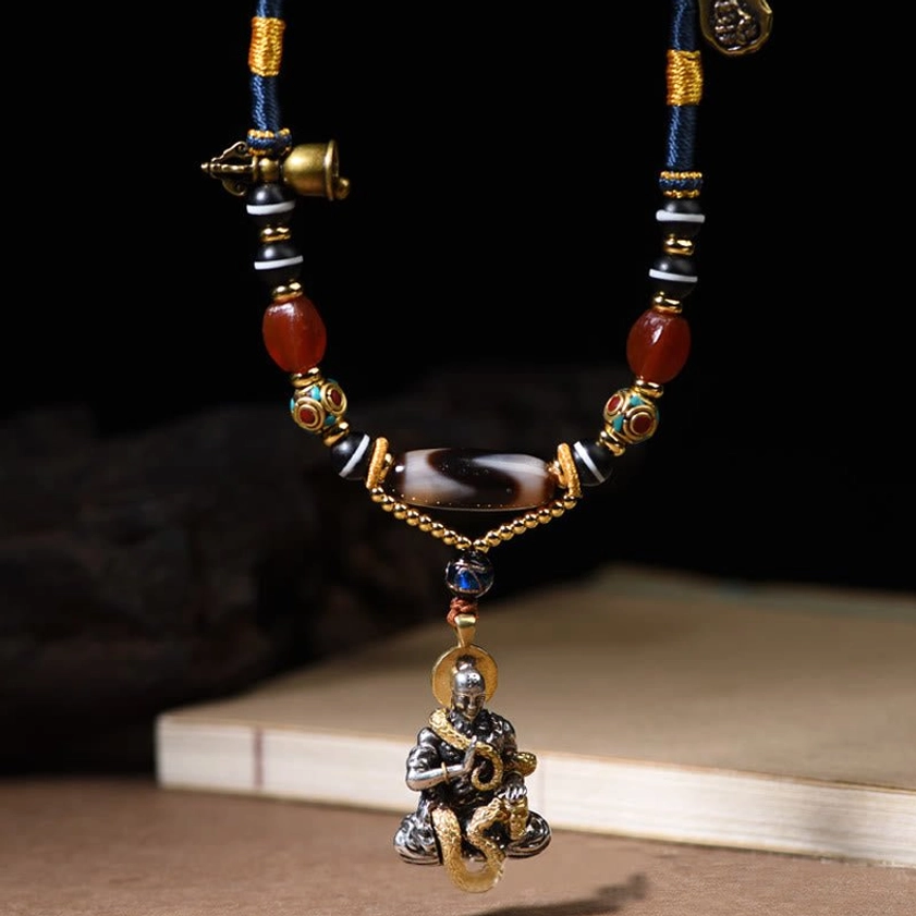 Buddhist dzi bead necklace vertical view with sitting Buddha snake design and metal bell charm