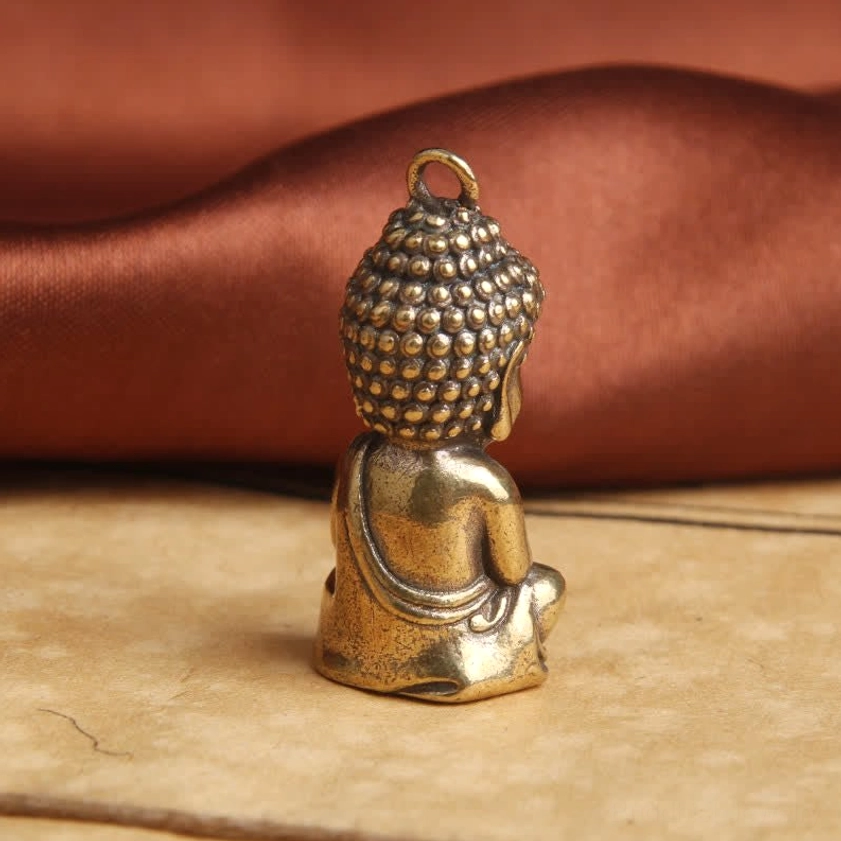 Rear view of Buddha keychain pendant revealing back of robe and top hanging bail for attachment