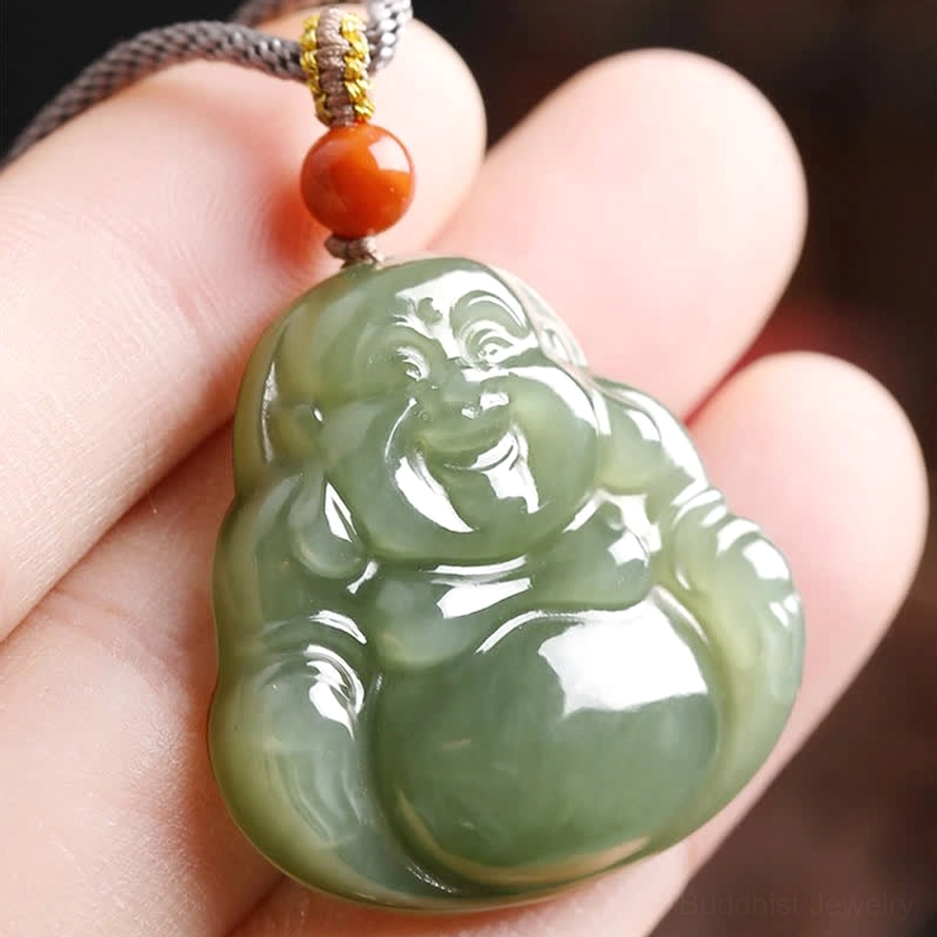 Maitreya Buddha jade pendant close-up of smiling face held in hand showing fine carving details
