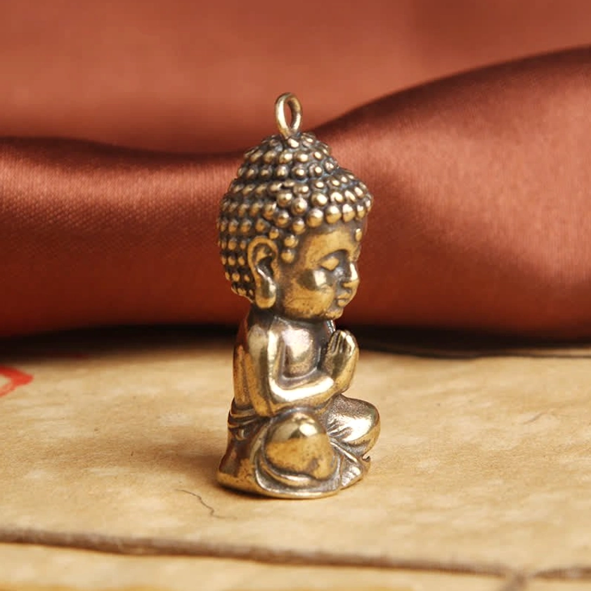 Right side profile of handcrafted Buddha keychain pendant displaying sculpted praying pose and robe details