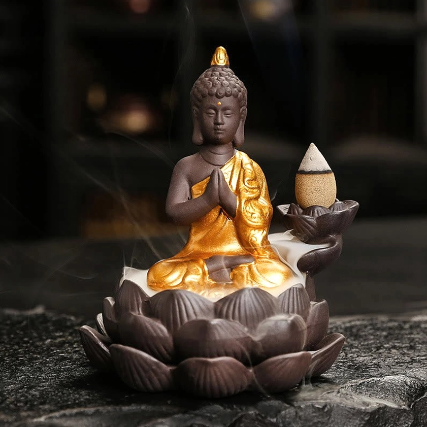 Handcrafted Buddha incense burner with prayer hands mudra in full gilded ceramic finish, frontal meditation pose view