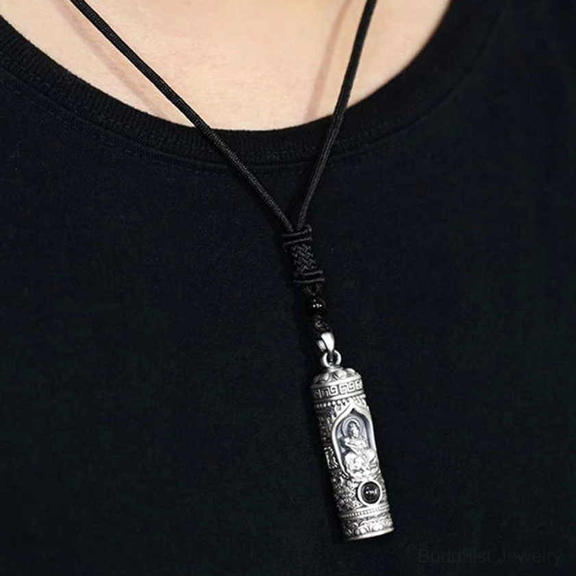 Guardian Buddha necklace worn on braided cord, close-up chest view showing aged silver finish and Buddhist pendant detail