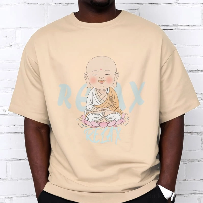 Person wearing beige Buddhist mindfulness tee with black bottoms, white brick wall background