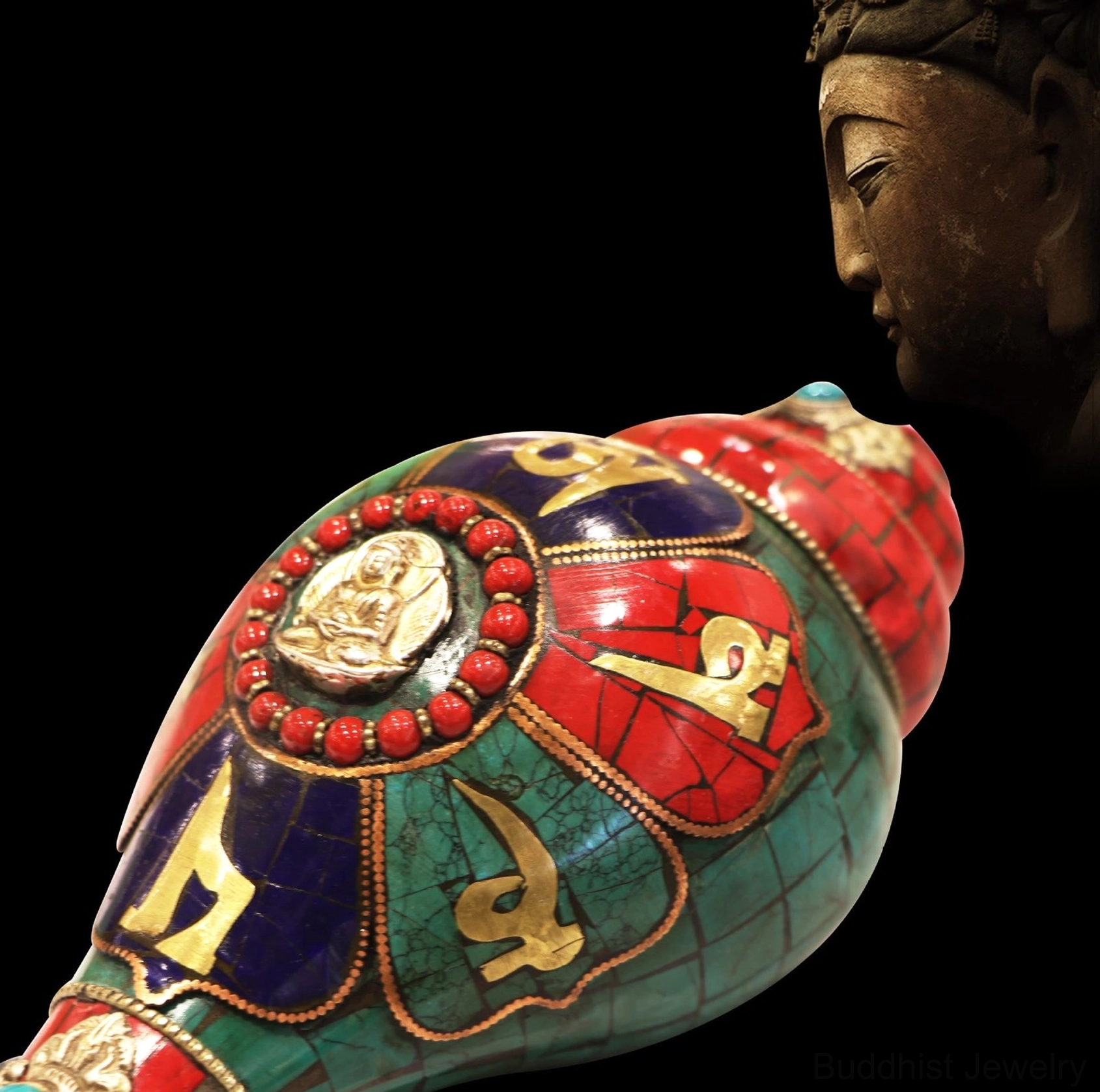 Close-up detail of Buddha relief with red bead halo and gold carved Om Mani Padme Hum mantras on Shankha conch