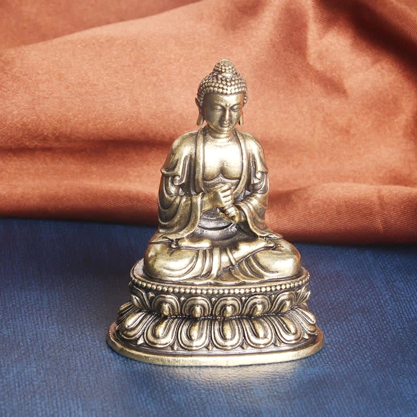 Spiritual Buddha statue front three-quarter angle, ushnisha hair bun detail, ornate lotus base design