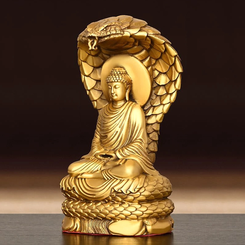 Close-up detail of Buddha Shakyamuni statue face - carved facial features and serpent head clarity