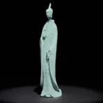 Standing Buddha sandstone meditation statue with serene expression, front three-quarter view in studio lighting