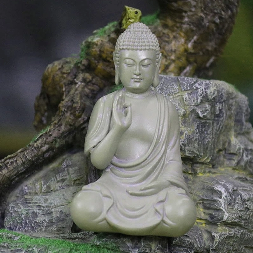 Detail shot of Buddha resin statue hands showing Abhaya mudra gesture of protection and fearlessness in Buddhist tradition