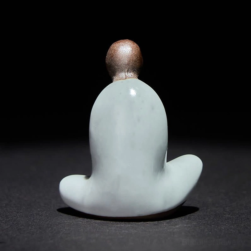Ceramic Buddha meditation statue rear view showing pale cyan glazed robe