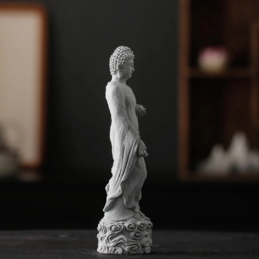 Rear view of handcrafted Buddha statue showing detailed robe carving and cloud base