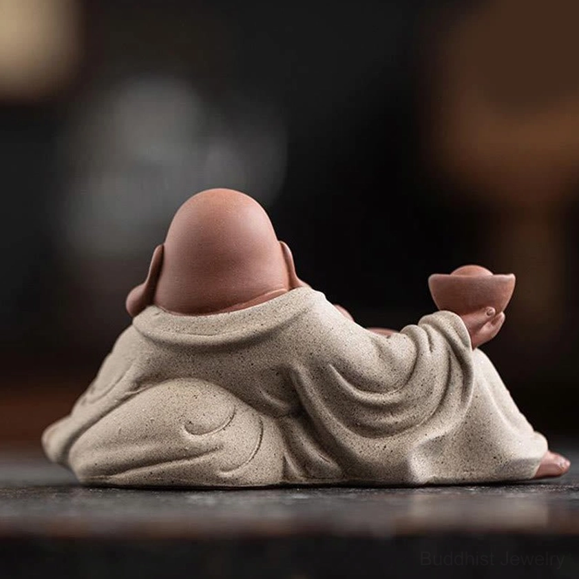 Laughing Buddha back view on wooden desktop, beige robes, purple clay craftsmanship detail, wealth ingot position