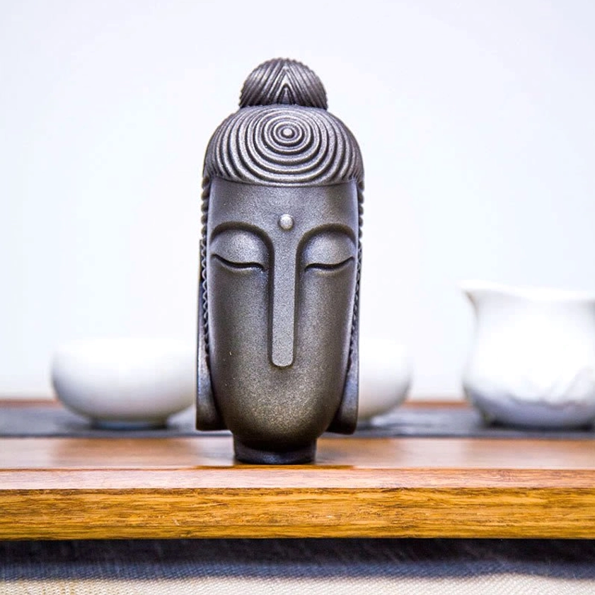 Buddhist statue showing closed eyes and intricate carved details handcrafted artisan work
